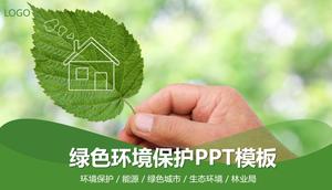 Umweltschutz PPT-Vorlage mit grünem Blatthintergrund in der Hand
